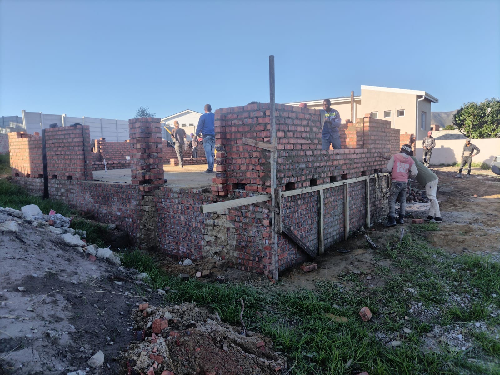 First lifts of facebrick wall coming out of the foundations