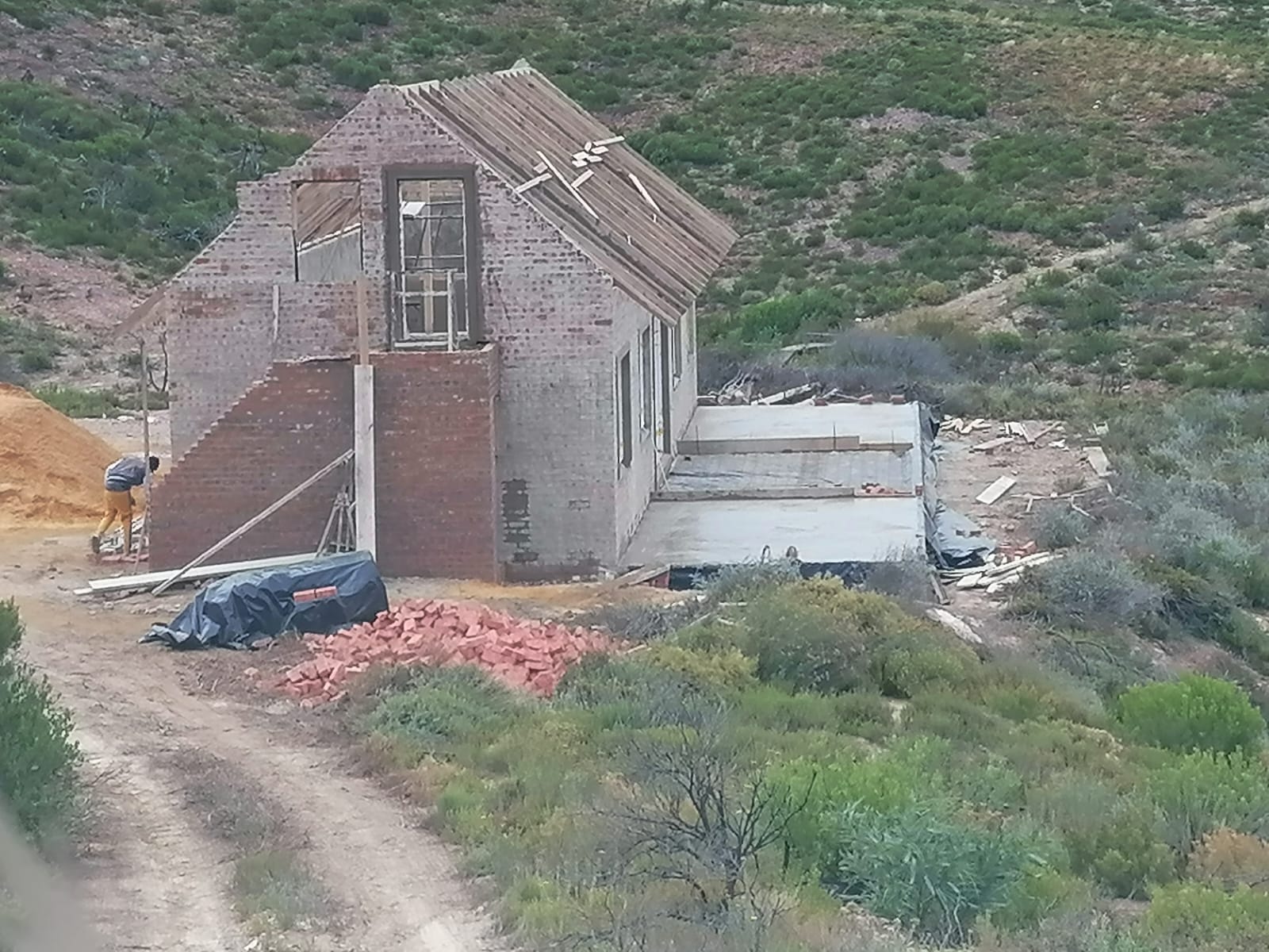 Double-storey facebrick home under construction on a Klein Karoo hillside