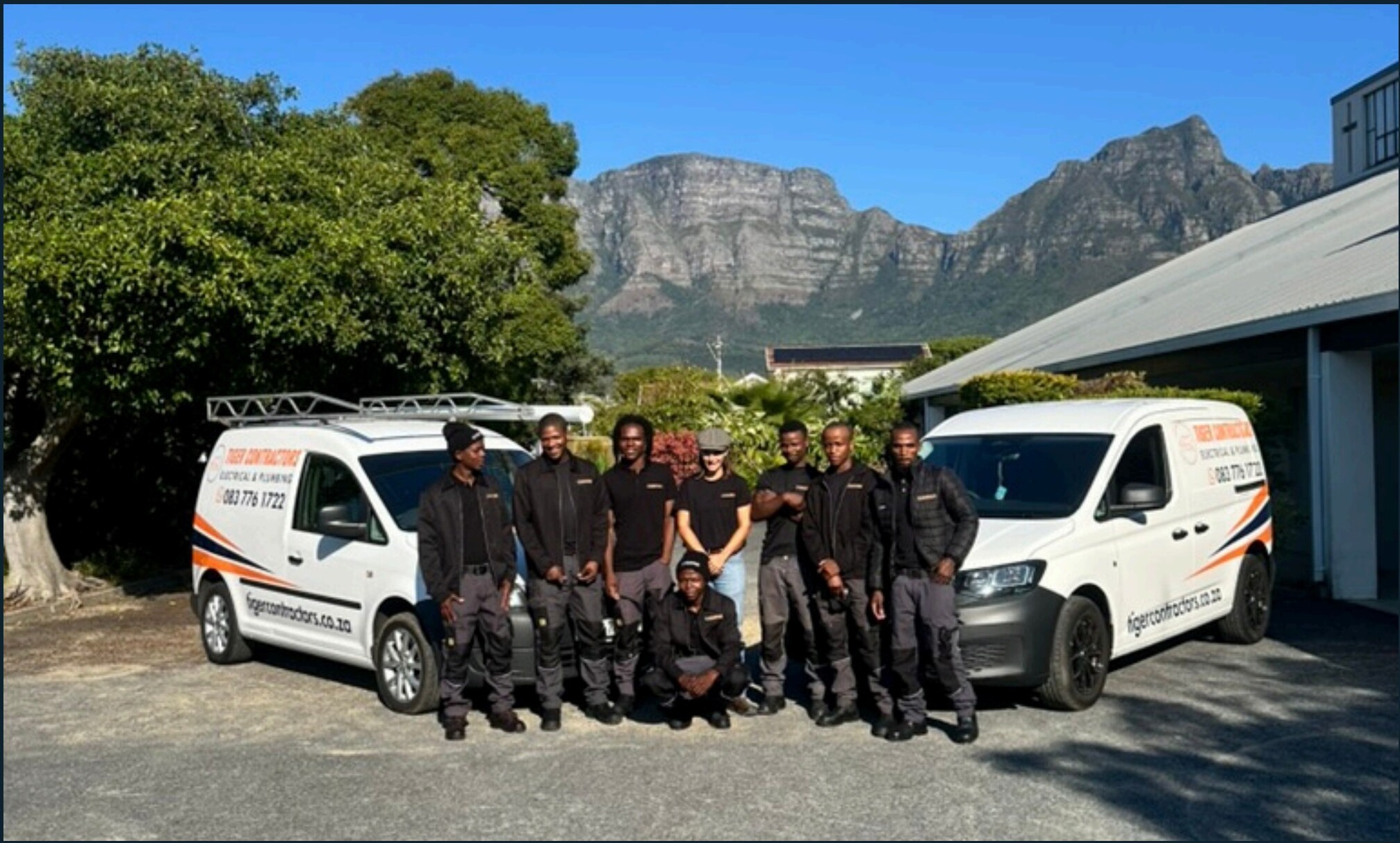 The Tiger Contractors team with their vans